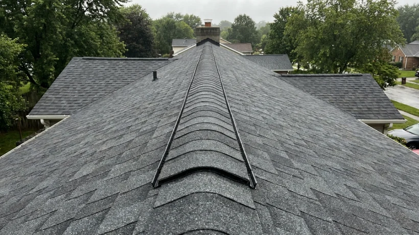 Continuous ridge vent installed on a residential asphalt shingle roof for proper ventilation.