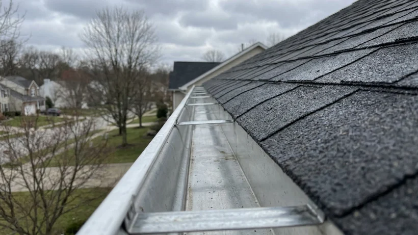 A clean rain gutter perfectly aligned with the roof edge, free of pine needles and debris.