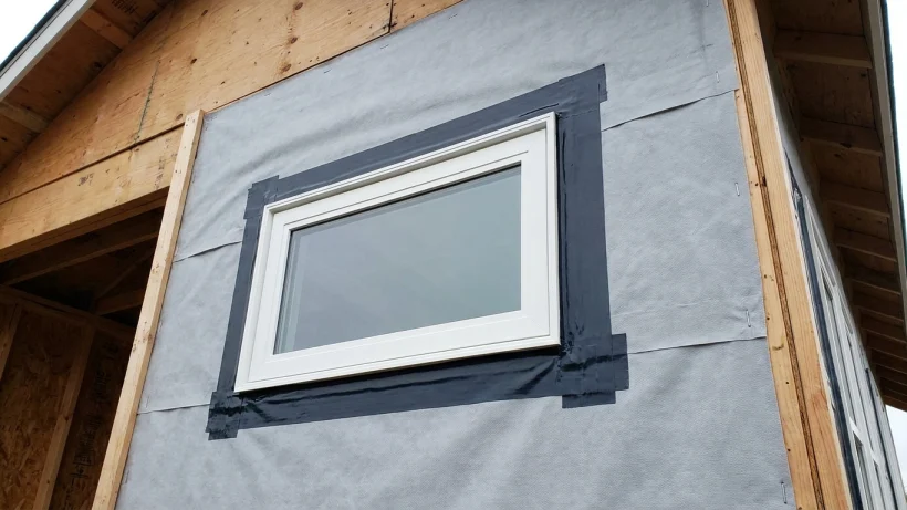 Properly flashed new replacement window integrated with exterior house wrap.